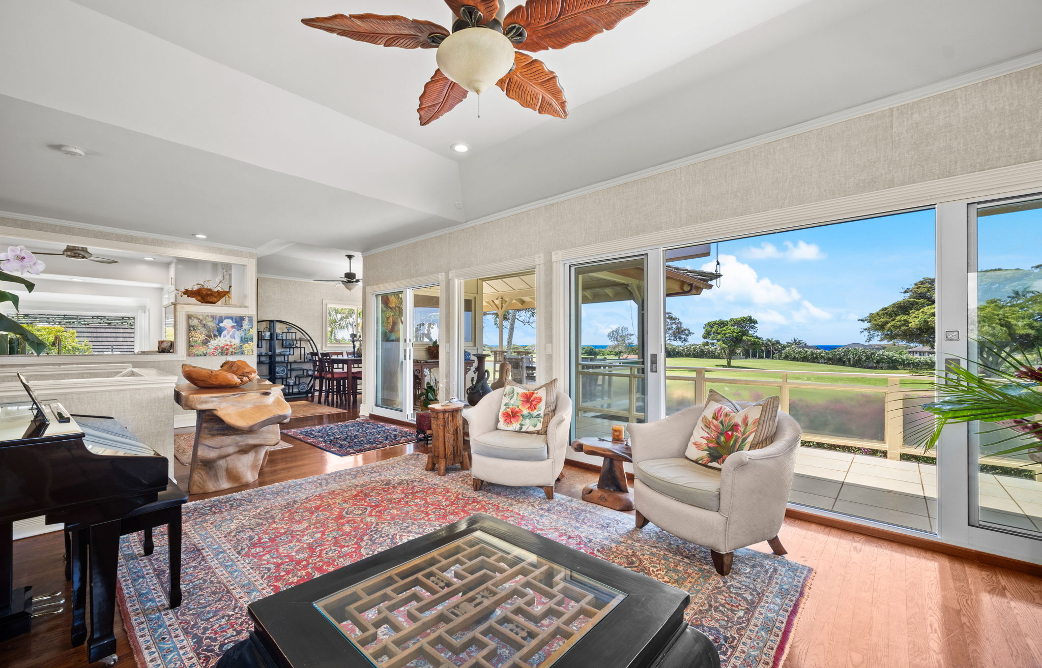 Main living room with Fleetwood glass doors opening to fairway and ocean views