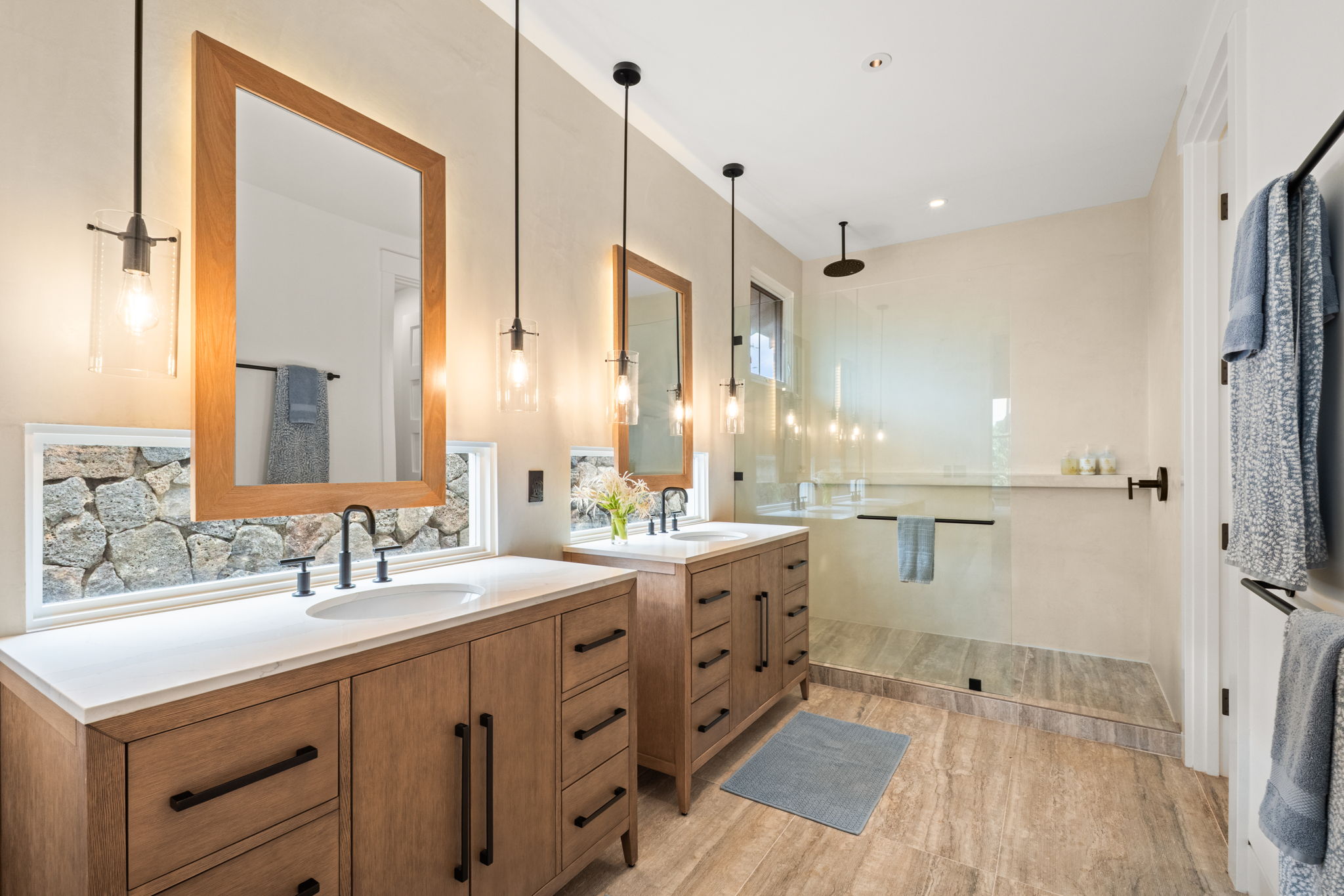Primary bathroom with dual vanities and walk-in shower