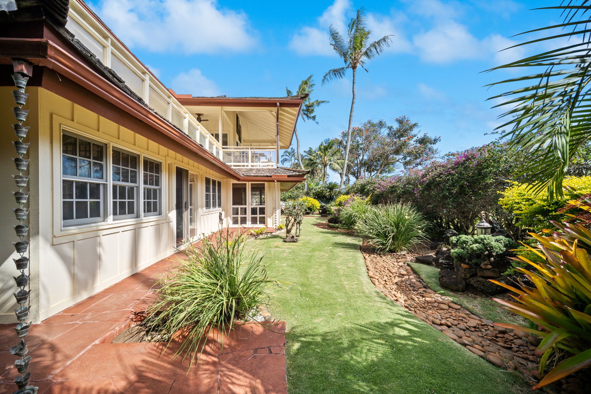 Side yard with curated tropical landscaping