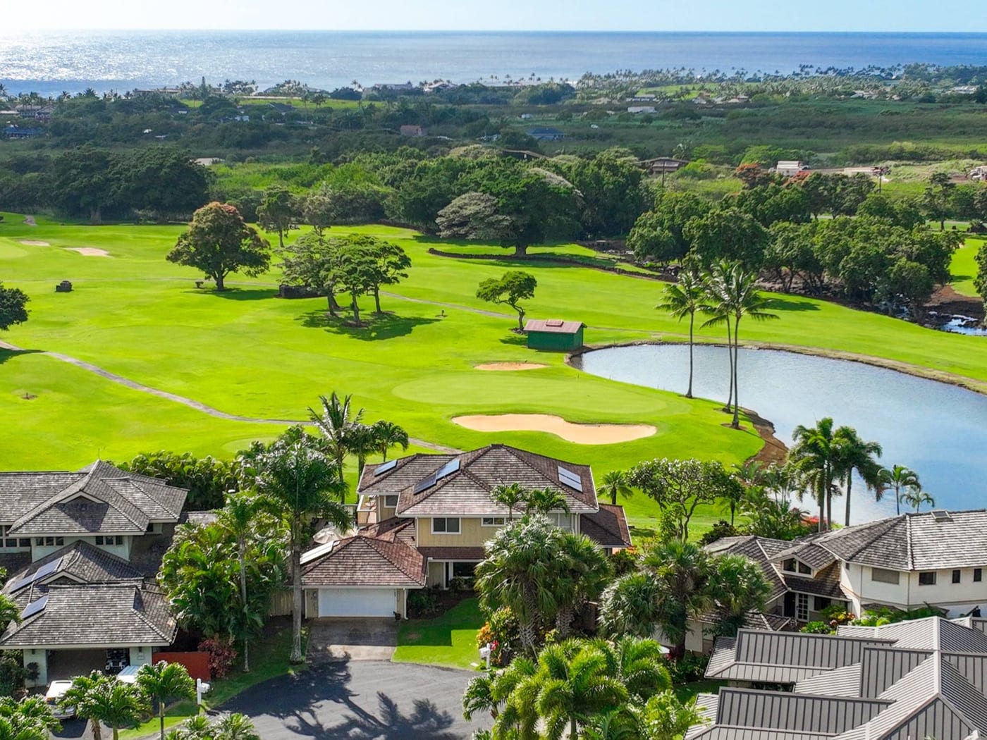 Aerial of Kiahuna Golf Village single-family homes surrounded by golf course greenbelts in Poipu, Kauai